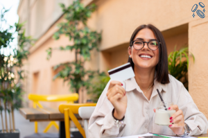 Woman drinking smoothie and holding debit card